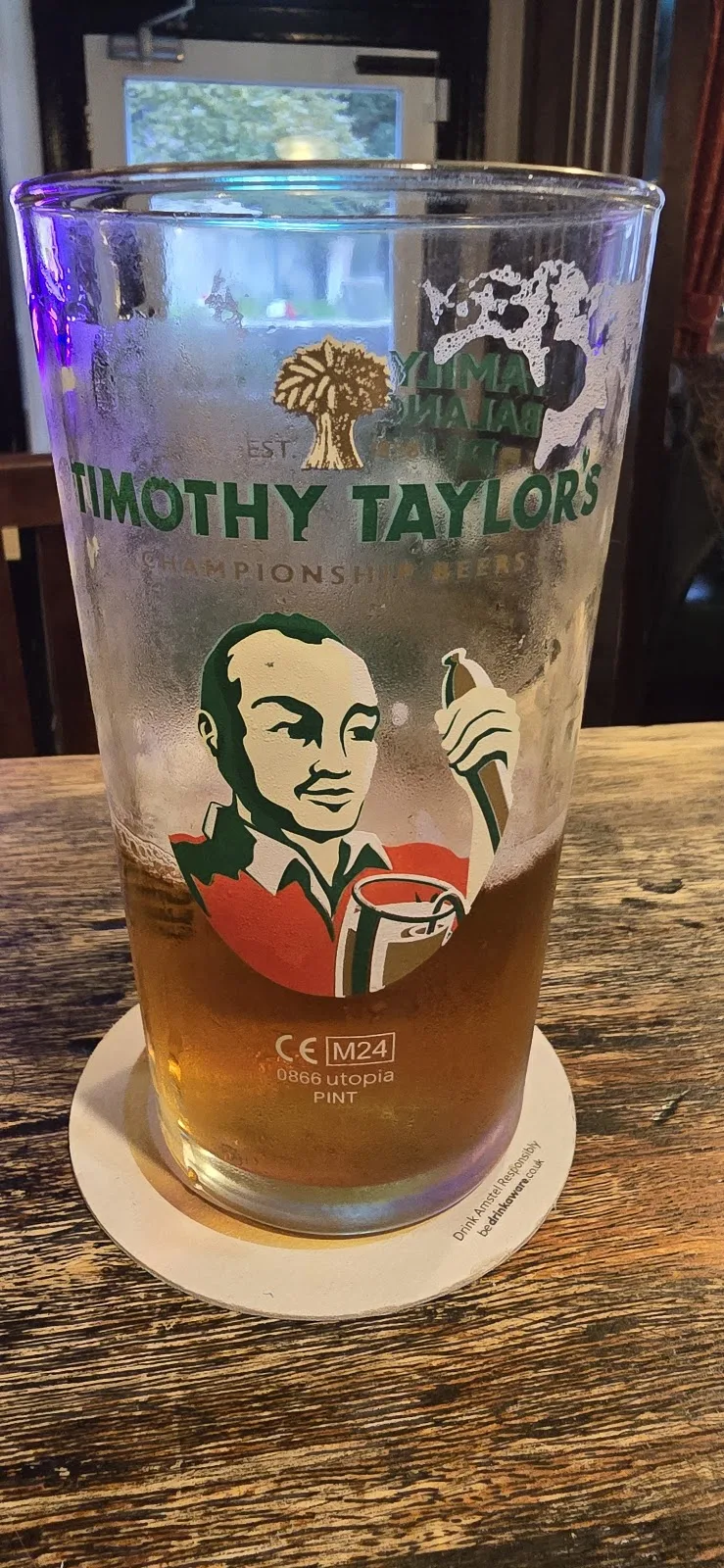 A pint of ale on a wooden table at The Robin Hood