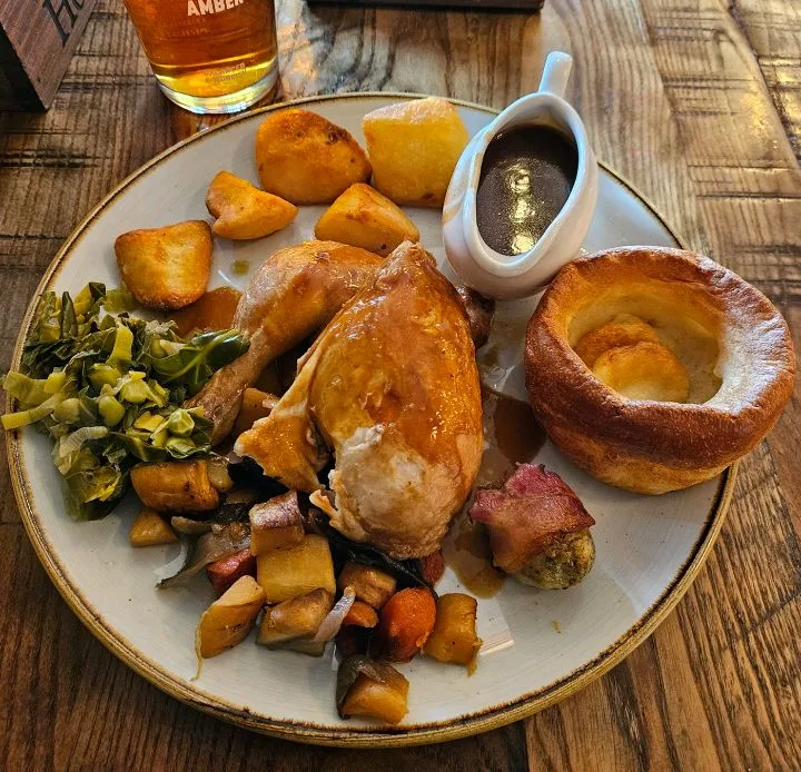 A Sunday roast at The Robin Hood: roast chicken, Yorkshire pudding, roast potatoes, greens and a jug of gravy